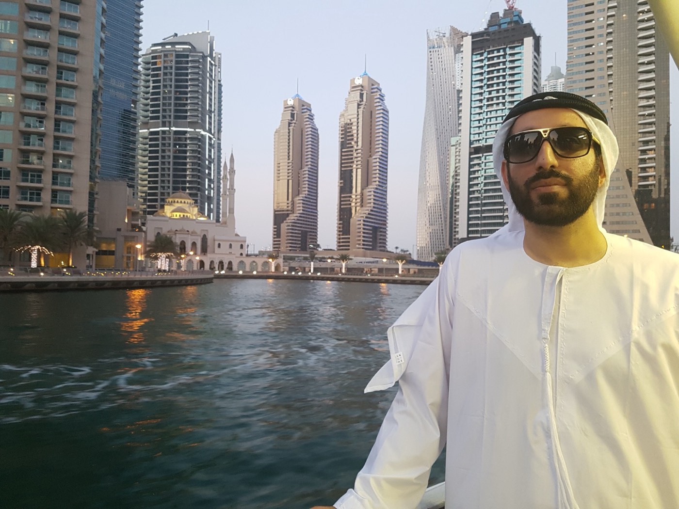 Kaiser Khan in traditional Emirati dress on the water at Dubai Marina