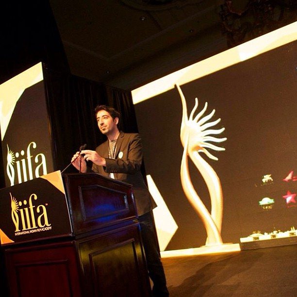 Kaiser Khan speaking on stage at the IIFA Awards