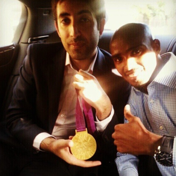 Kaiser Khan holding Sir Mo Farah's London 2012 Olympic gold medal, with Mo Farah beside him