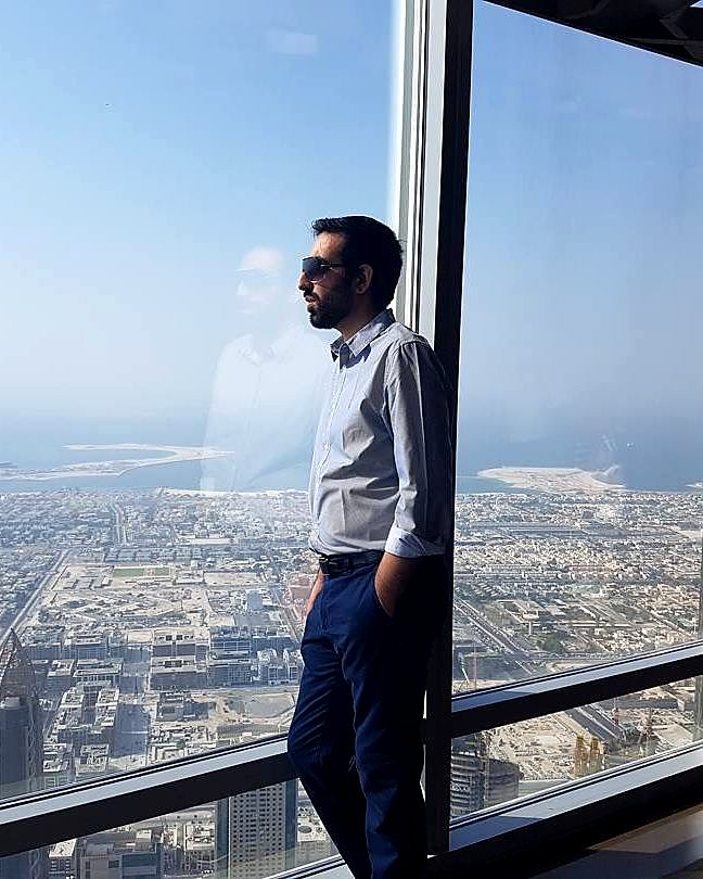 Kaiser Khan at a high window overlooking Dubai